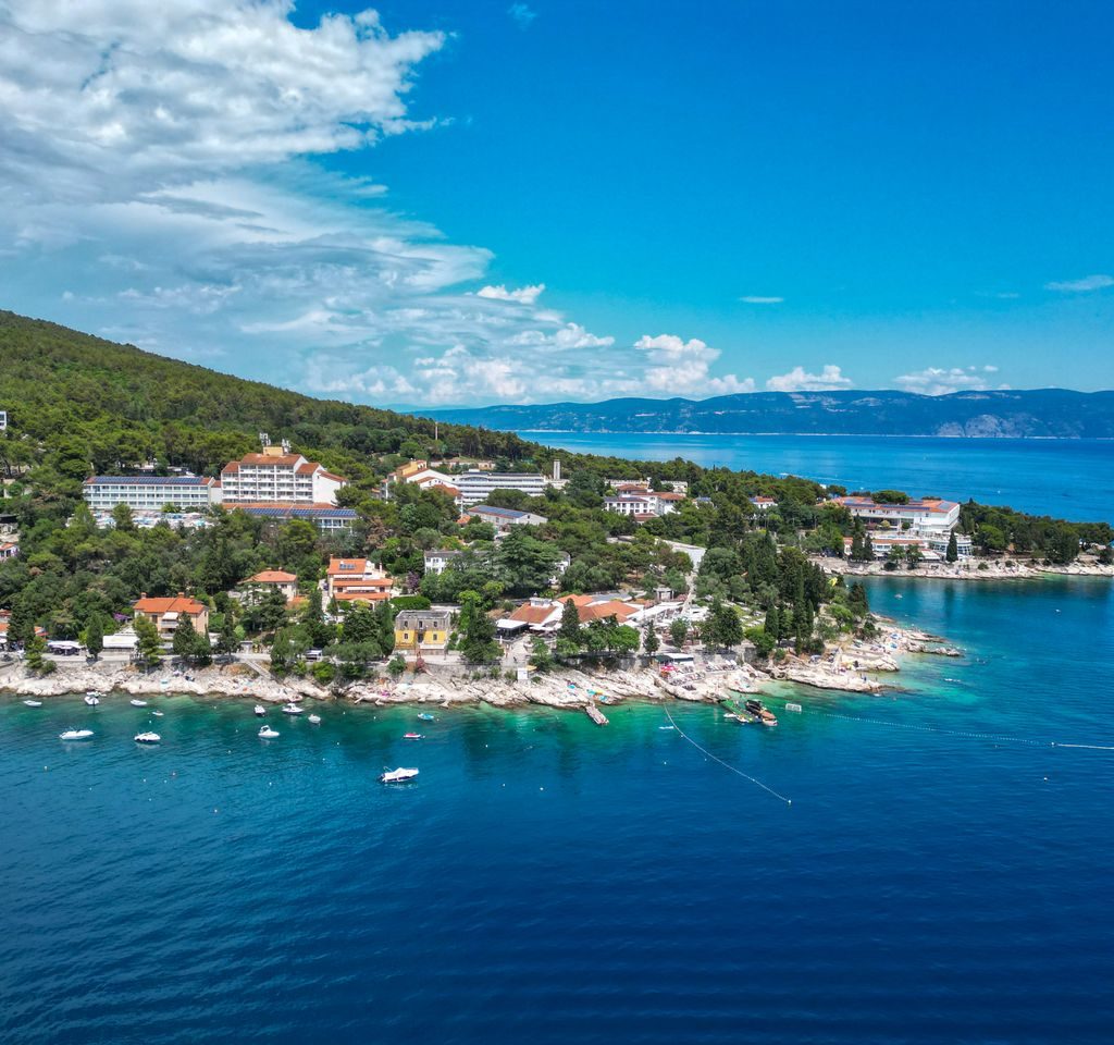 Stunning aerial photograph of Rabac's beautiful coastline, highlighting green landscapes and turquoise waters.